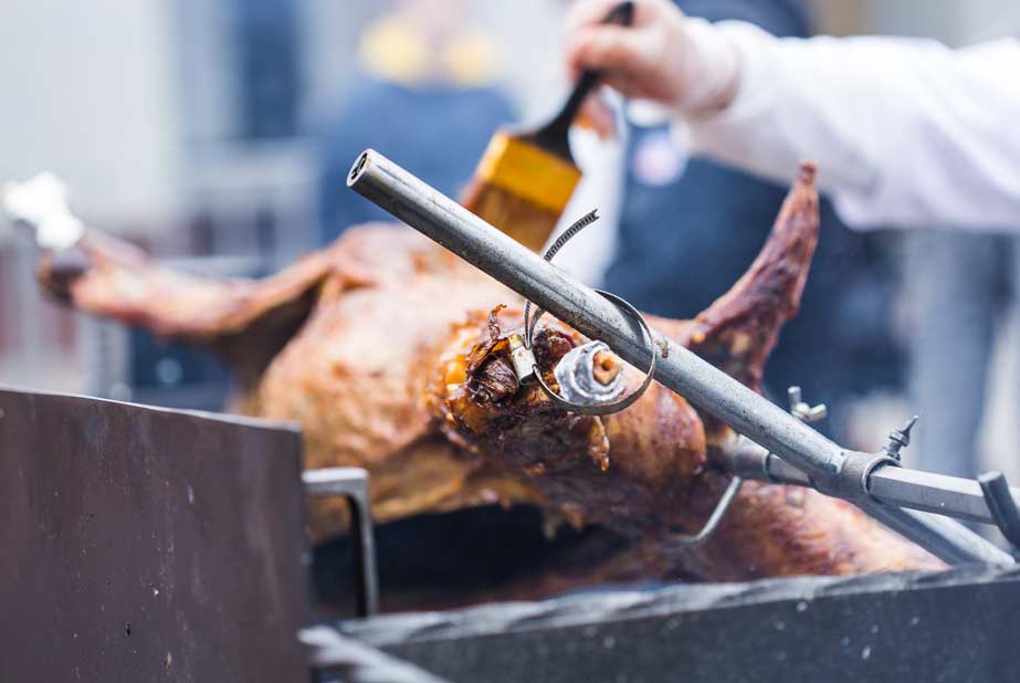 the-carcass-of-a-lamb-is-roasted-on-a-spit-close-2021-12-09-09-25-46-utc